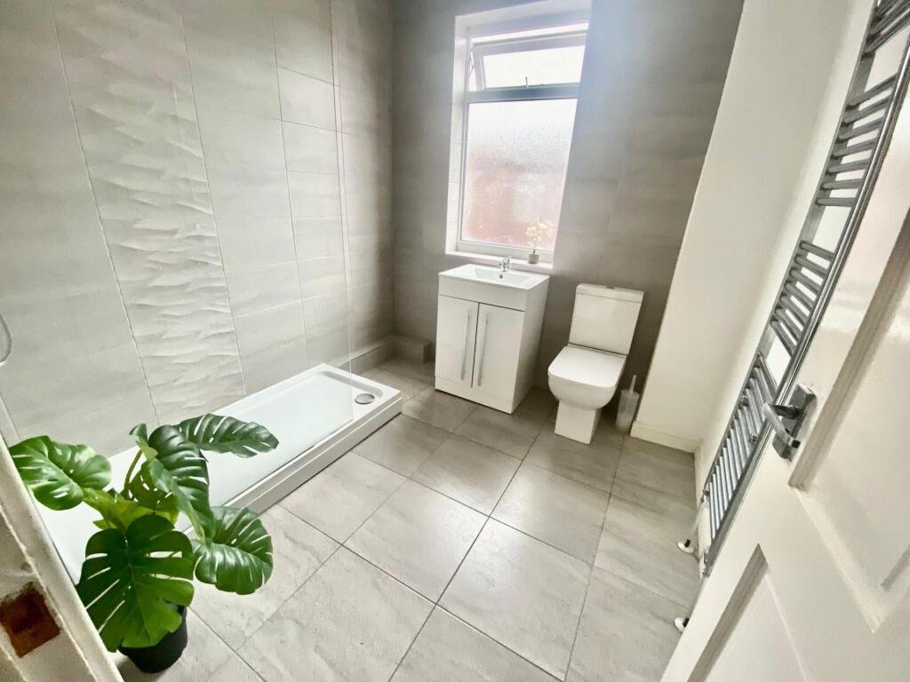 Bright and modern bathroom featuring a spacious...