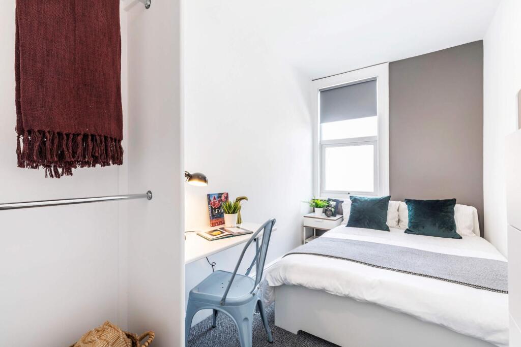 Bright, neatly presented bedroom with a comfort...