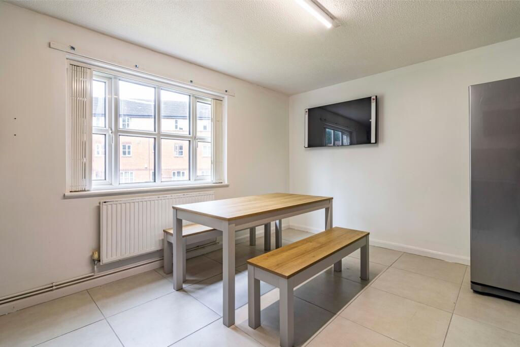 A modern kitchenette with ample space for dinin...