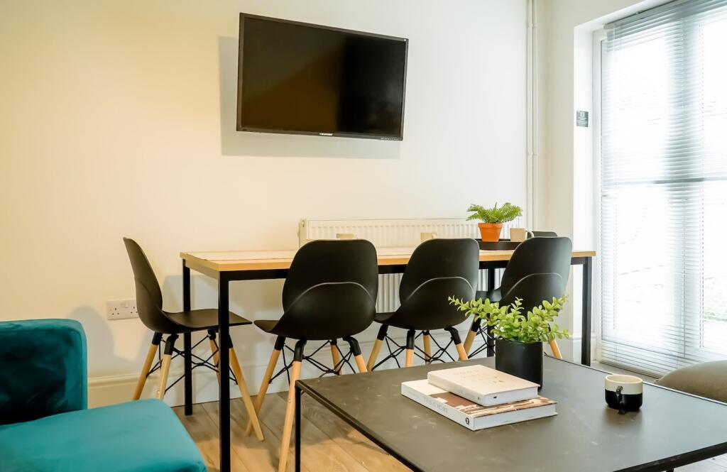 A stylish communal workspace featuring a modern...