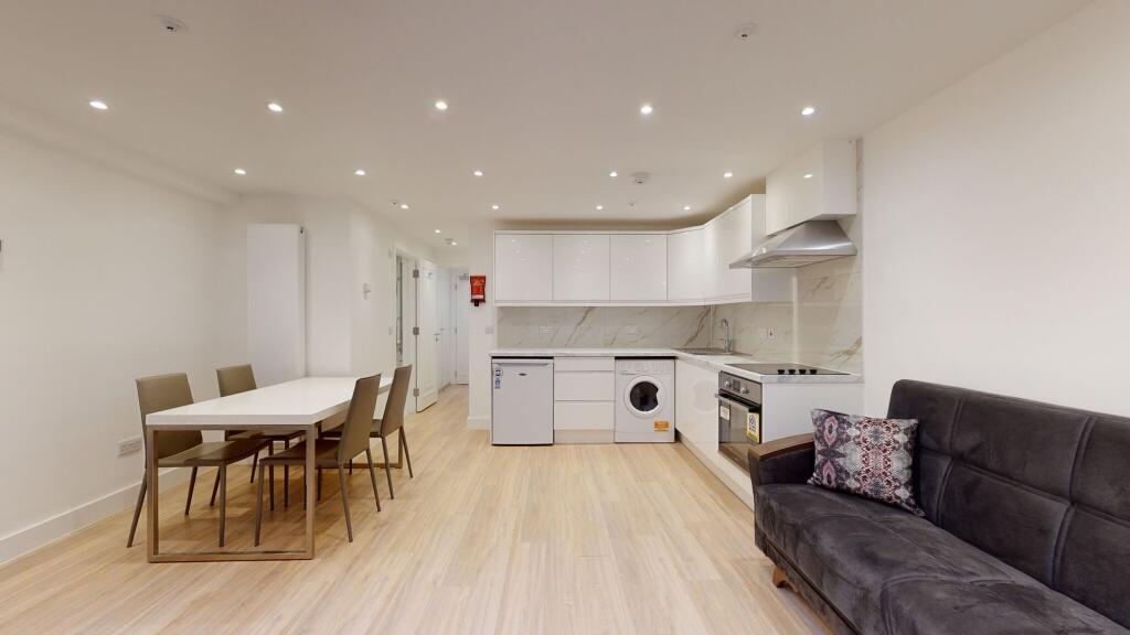 Bright and modern kitchen and dining area featu...