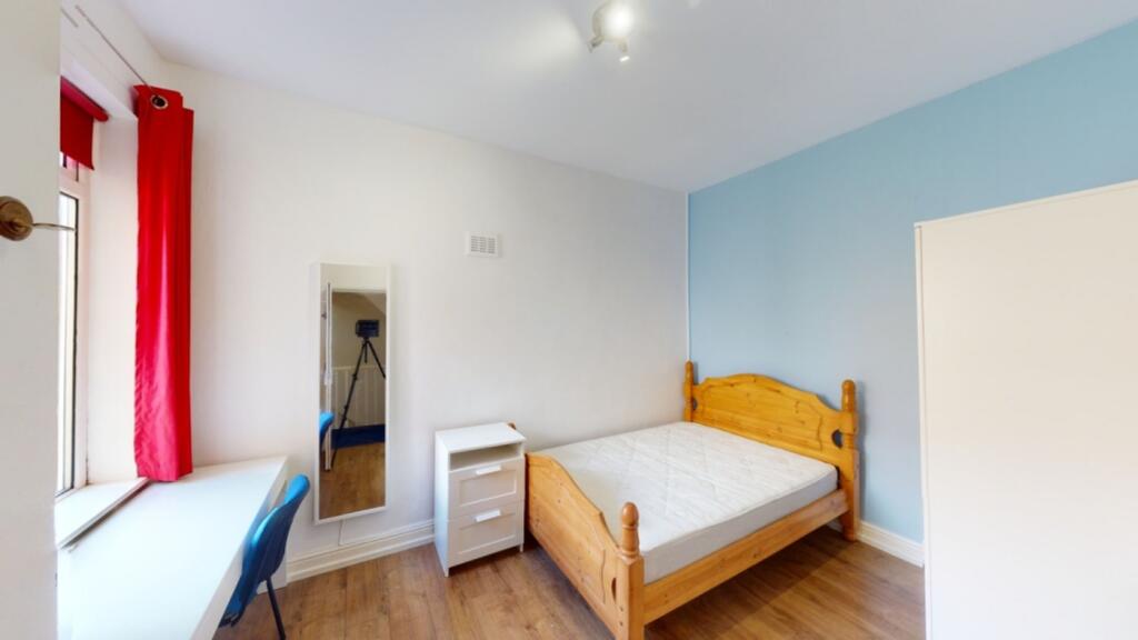 A bright and inviting double bedroom featuring ...