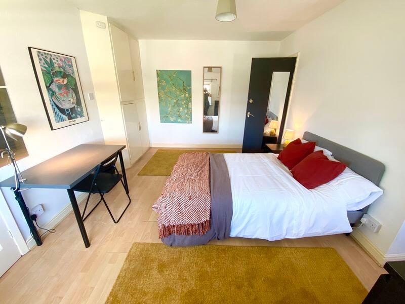 Bright and spacious master bedroom featuring a ...
