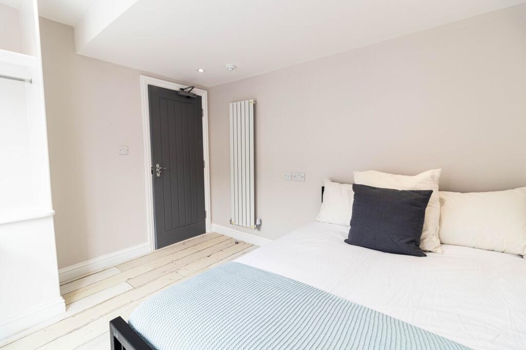 A bright and inviting double bedroom featuring ...