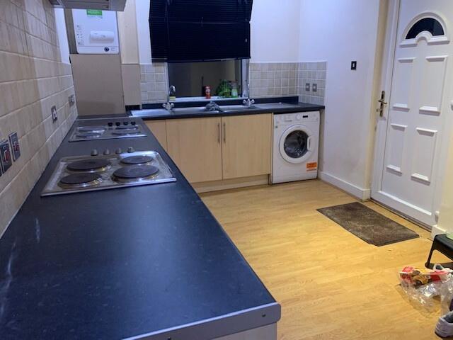 A well-maintained kitchen featuring a black cou...