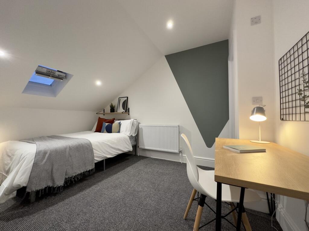 A bright and inviting double bedroom featuring ...