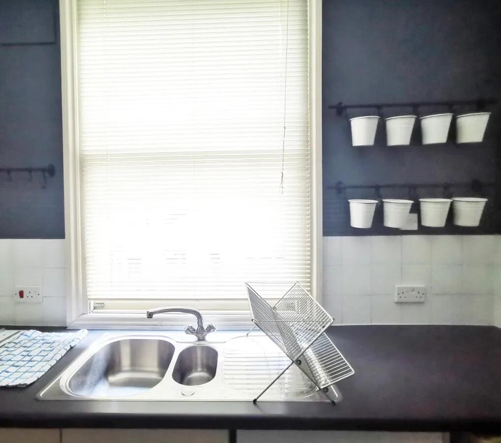 Bright and tidy kitchen featuring a dual stainl...