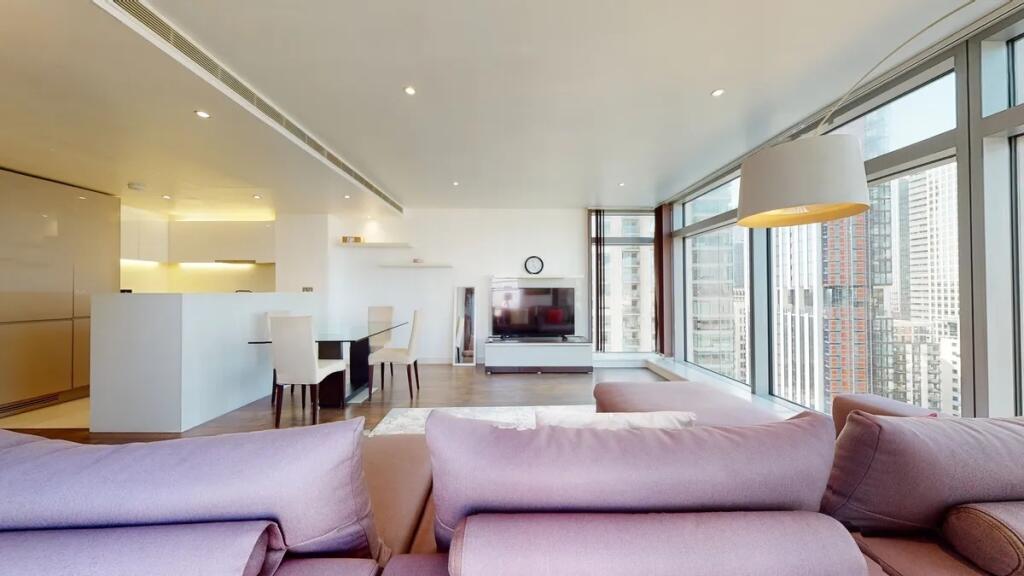 A spacious contemporary living room featuring l...