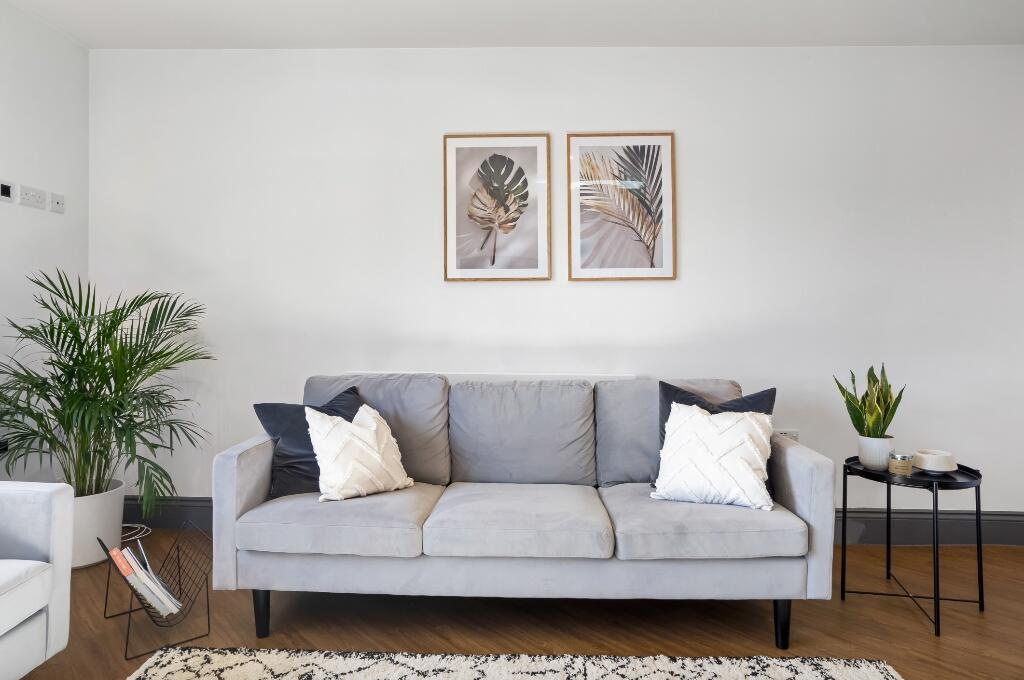 A modern living room featuring a stylish gray t...
