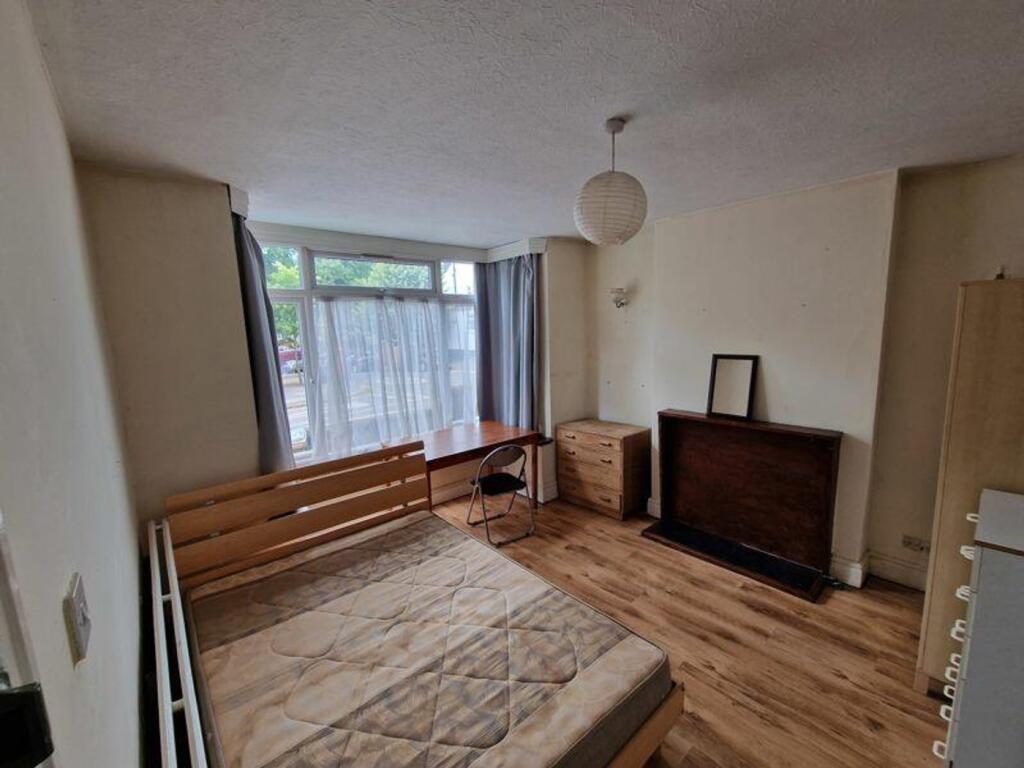A spacious and inviting double bedroom featurin...