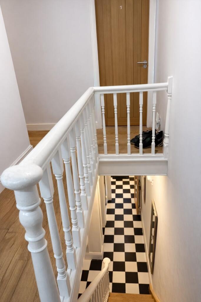 Bright, freshly painted stairwell with classic ...