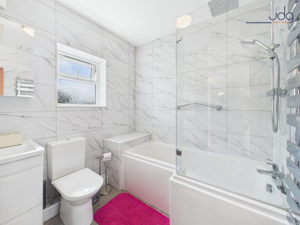 A contemporary bathroom with a rainfall shower