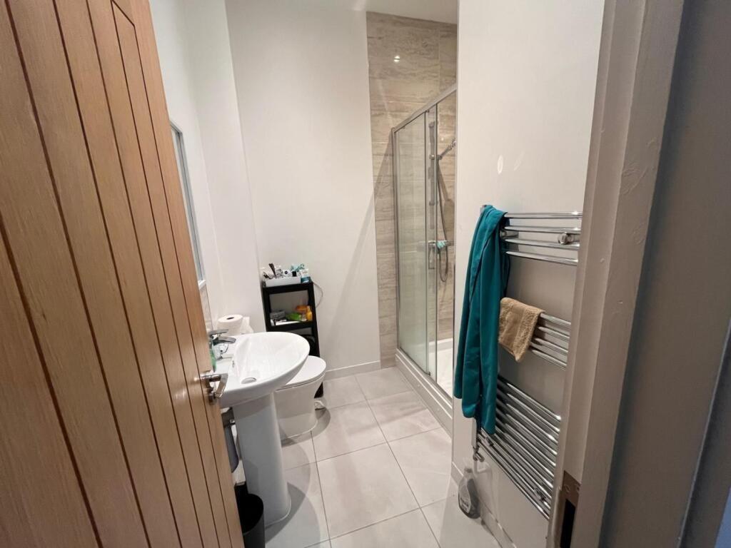 A modern bathroom featuring a spacious walk-in ...