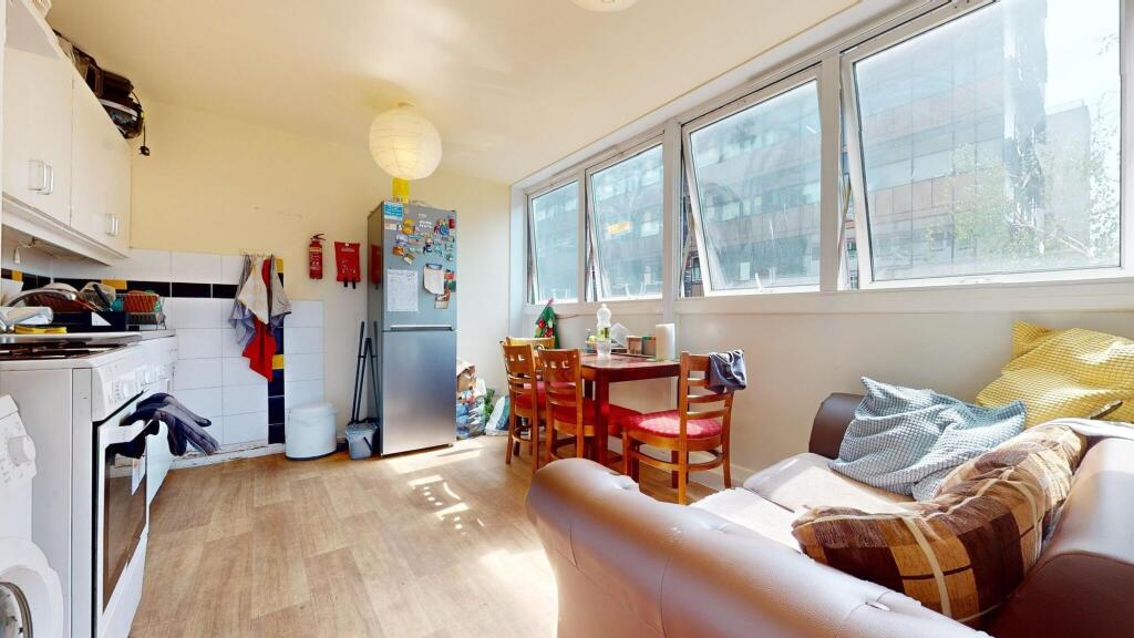 Bright and inviting kitchen space with large wi...
