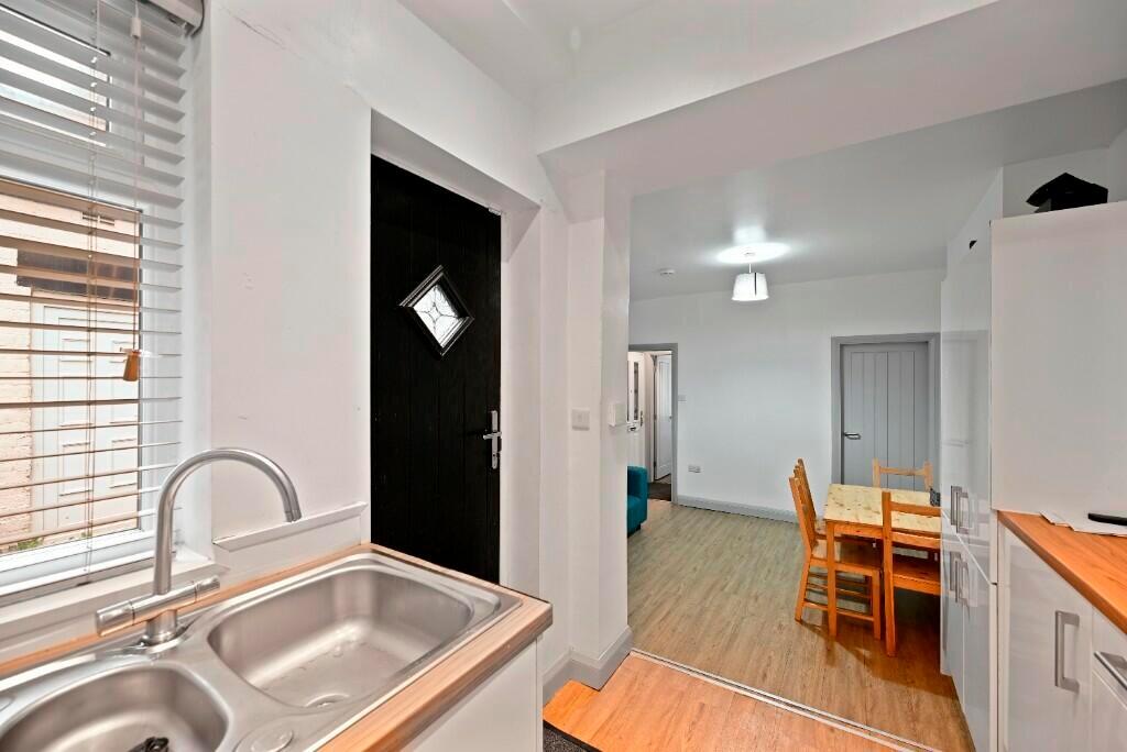 Bright and clean kitchen area featuring a doubl...