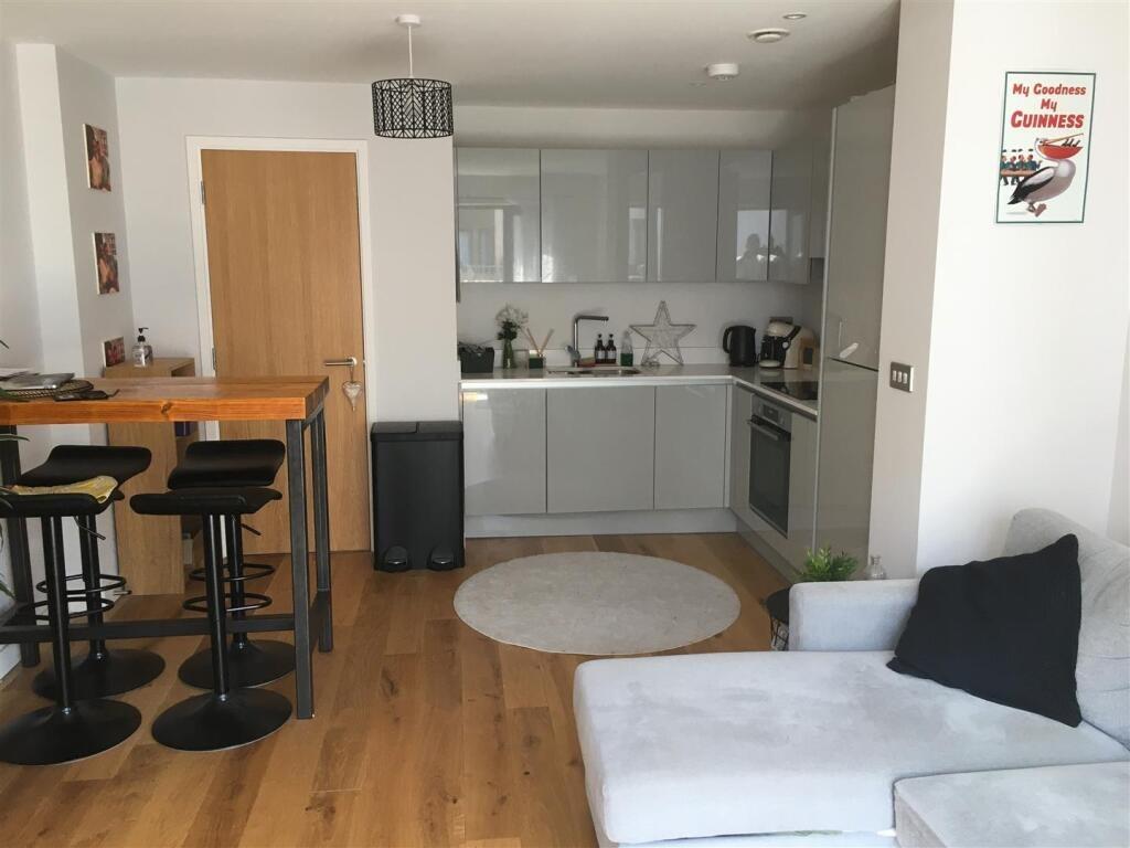 Bright and modern living room featuring a sleek...