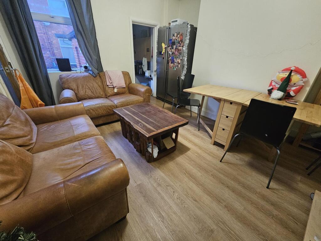 Bright, comfortable living room with leather so...