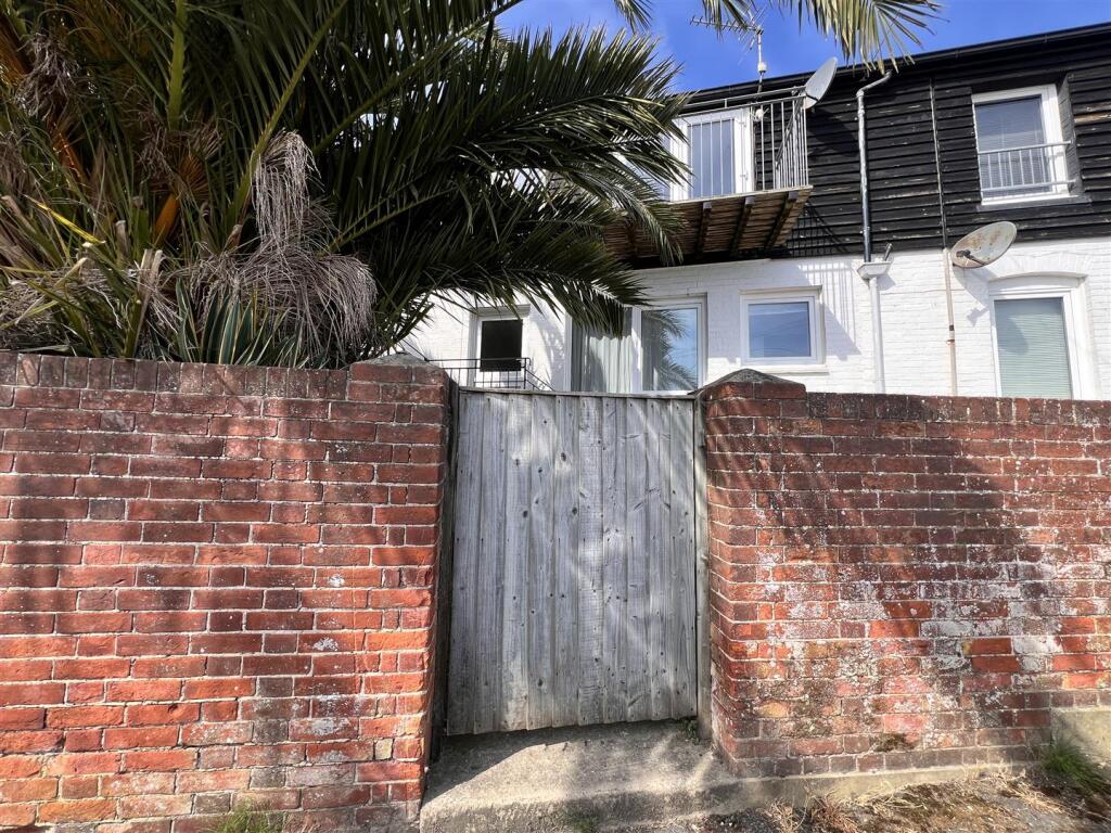 Wooden gate leading through to the staircase up to