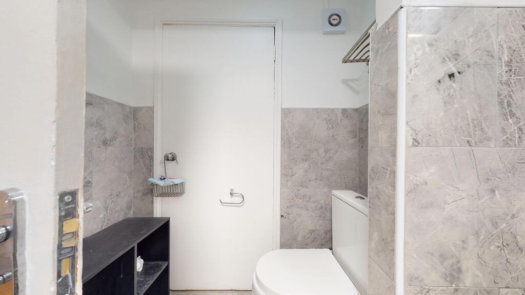 Bright and functional bathroom featuring a toil...