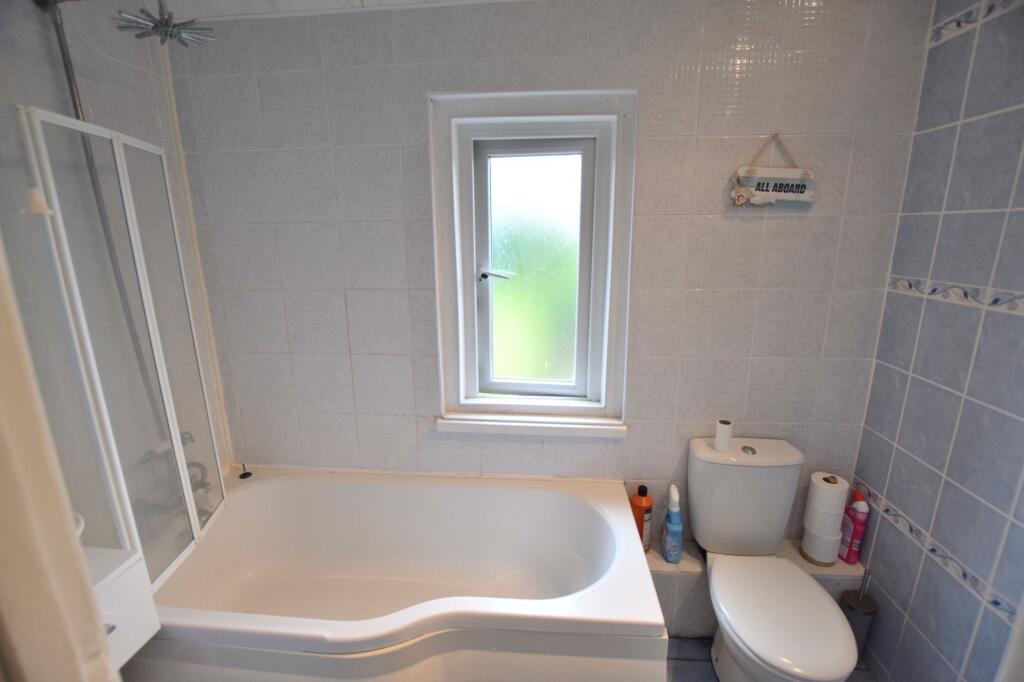 Bright and clean bathroom featuring a modern wh...
