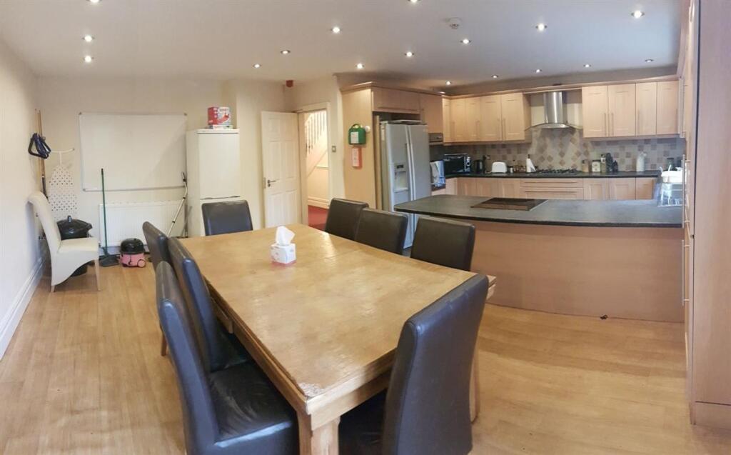 A modern kitchen and dining area featuring a la...