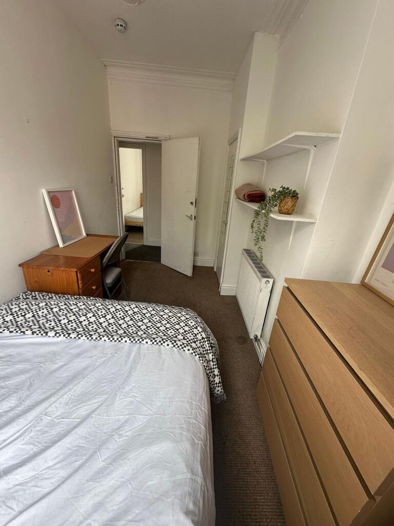 A cozy and well-maintained bedroom featuring a ...