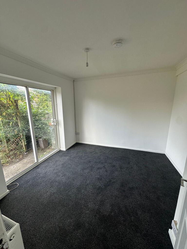 Bright and spacious bedroom featuring large sli...