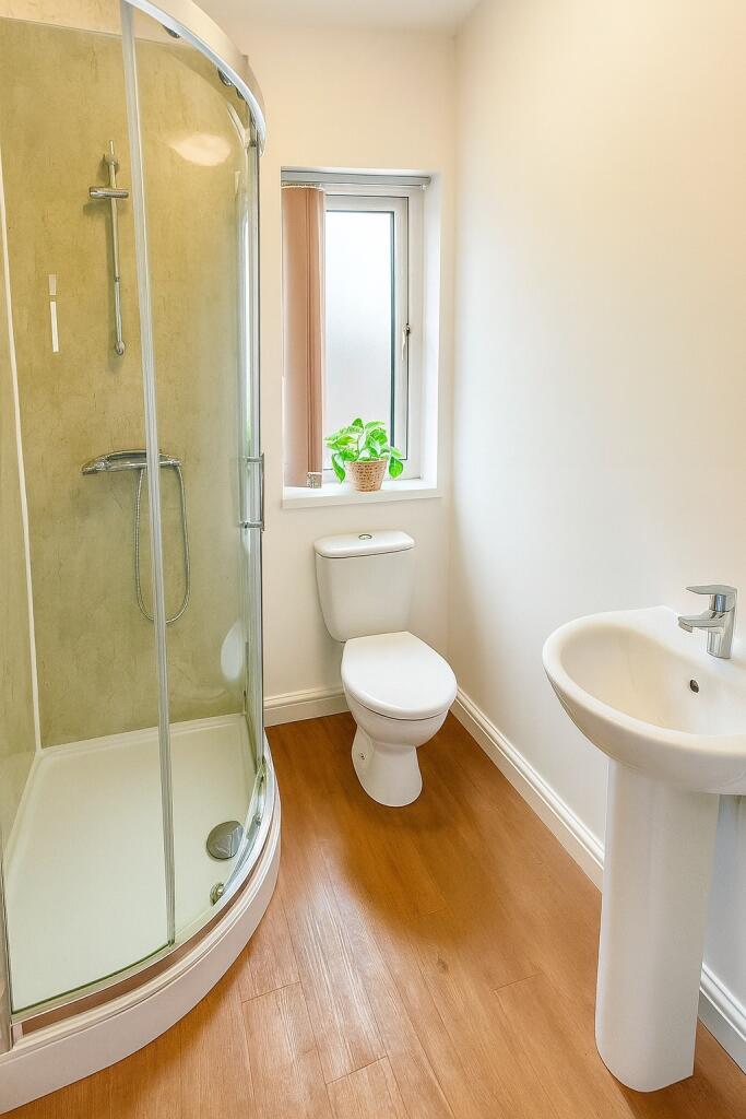 Bright and pristine bathroom featuring a modern...