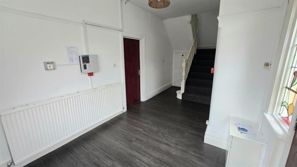 Bright, recently refreshed hallway with dark wo...