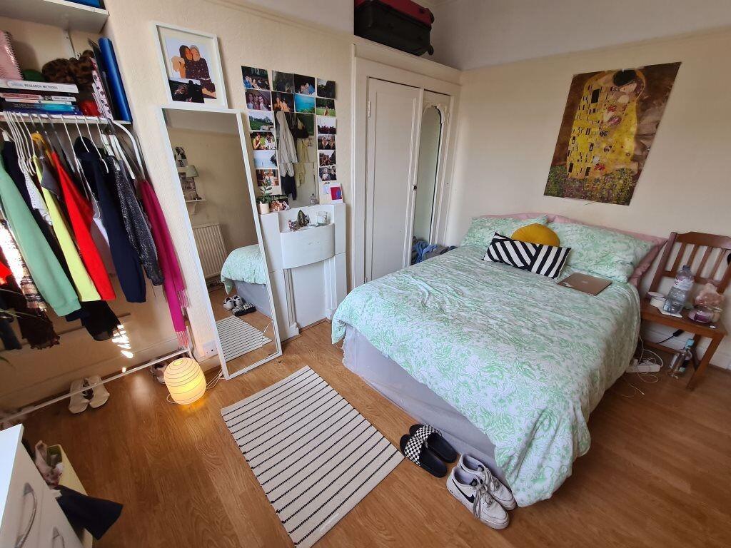 A cozy and well-organized double bedroom featur...