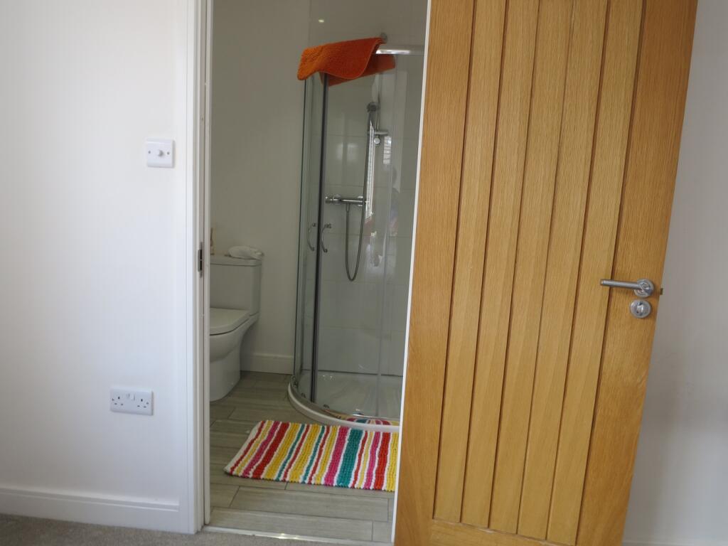 A bright and modern bathroom with a stylish sho...