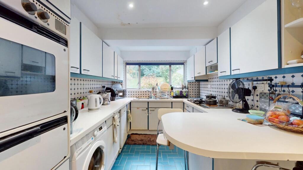 Bright and modern kitchen featuring ample natur...