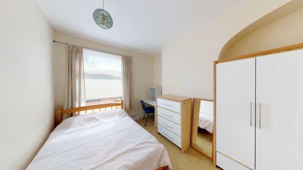 A neat and bright single bedroom featuring a co...