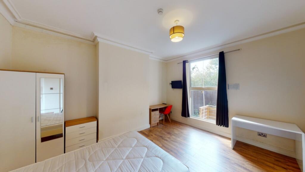 A bright and spacious double bedroom with a mod...