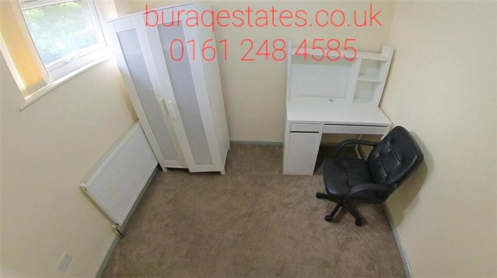 Compact, tidy bedroom with a wardrobe, desk and...