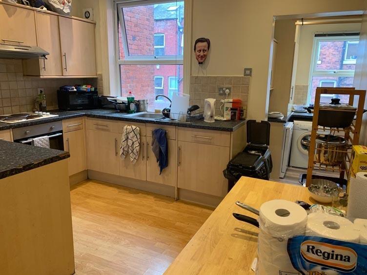A well-equipped kitchen featuring ample counter...