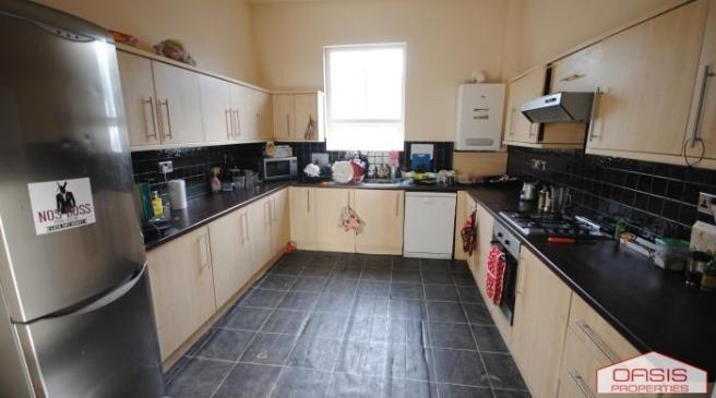 Bright and well-maintained kitchen with ample c...