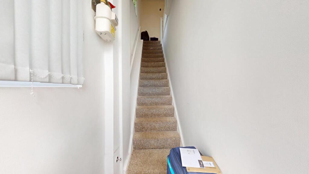 A bright and tidy staircase with carpeted steps...