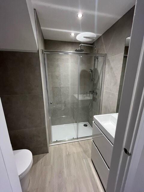 Modern bathroom with a spacious walk-in shower,...