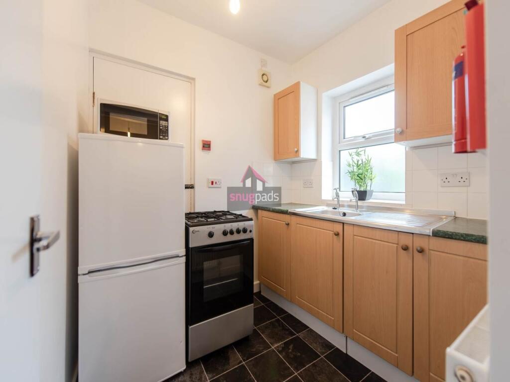 A neat and functional kitchen featuring wooden ...