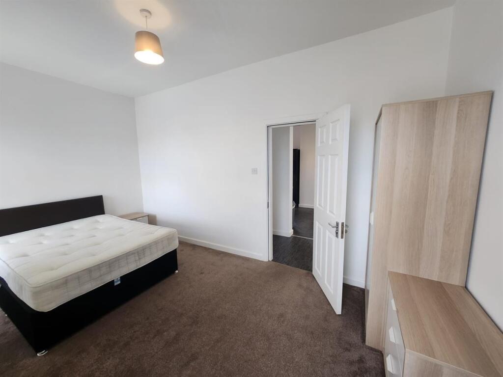 A clean and well-maintained bedroom featuring a...