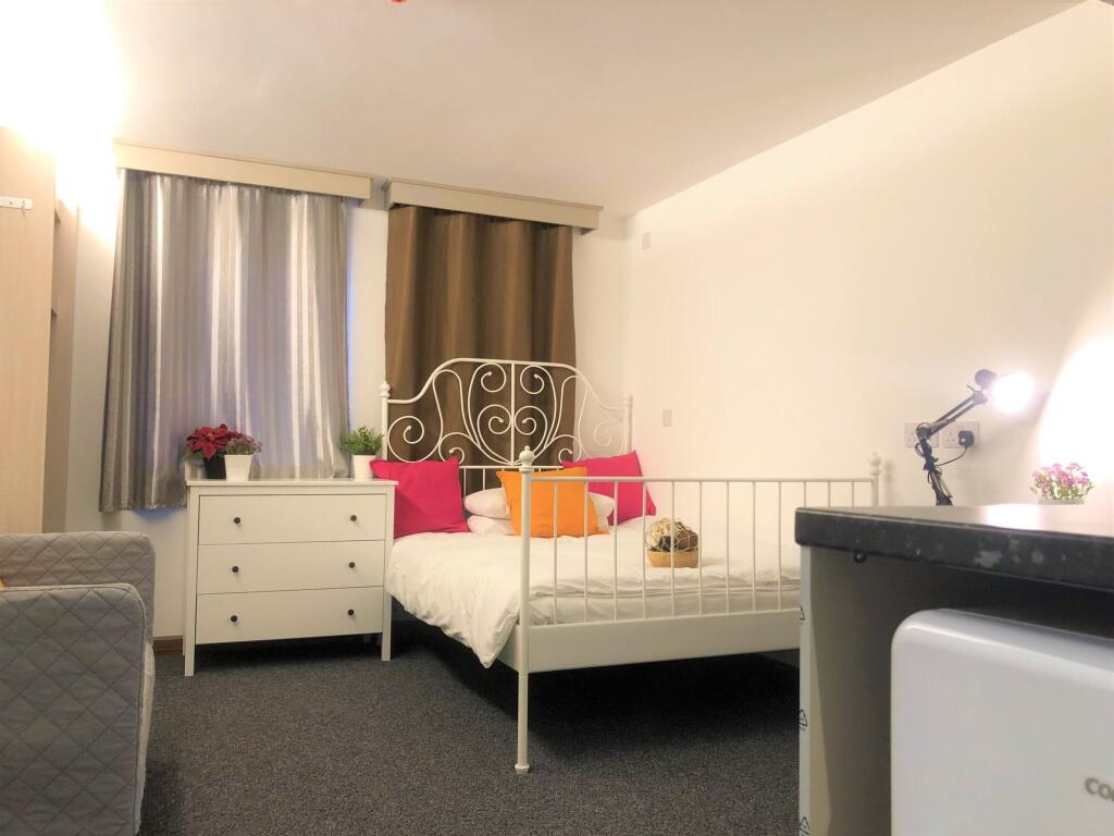 Bright and cozy double bedroom featuring a styl...
