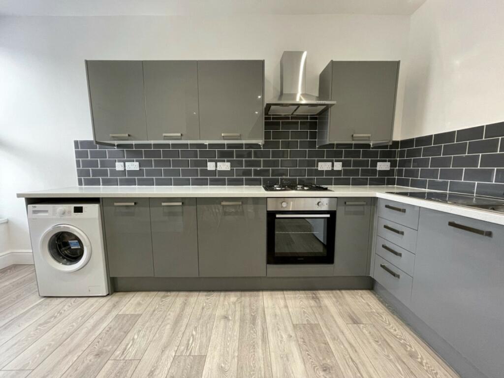 A modern and spacious kitchenette with sleek gr...