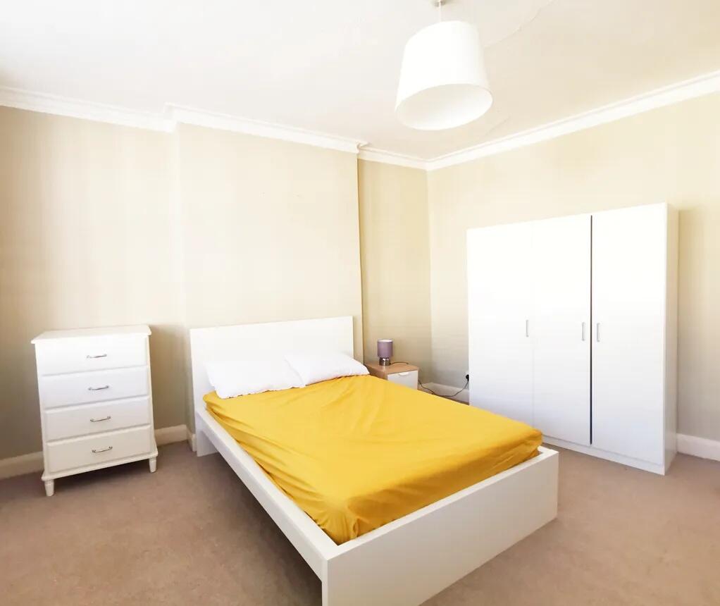 Bright and tidy double bedroom featuring a comf...