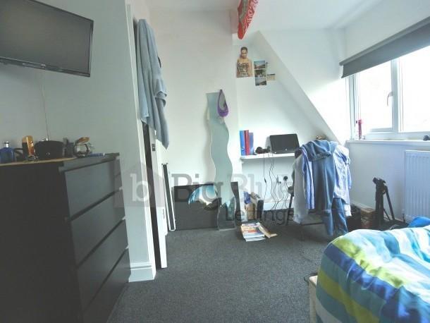 Bright and cozy master bedroom featuring a larg...