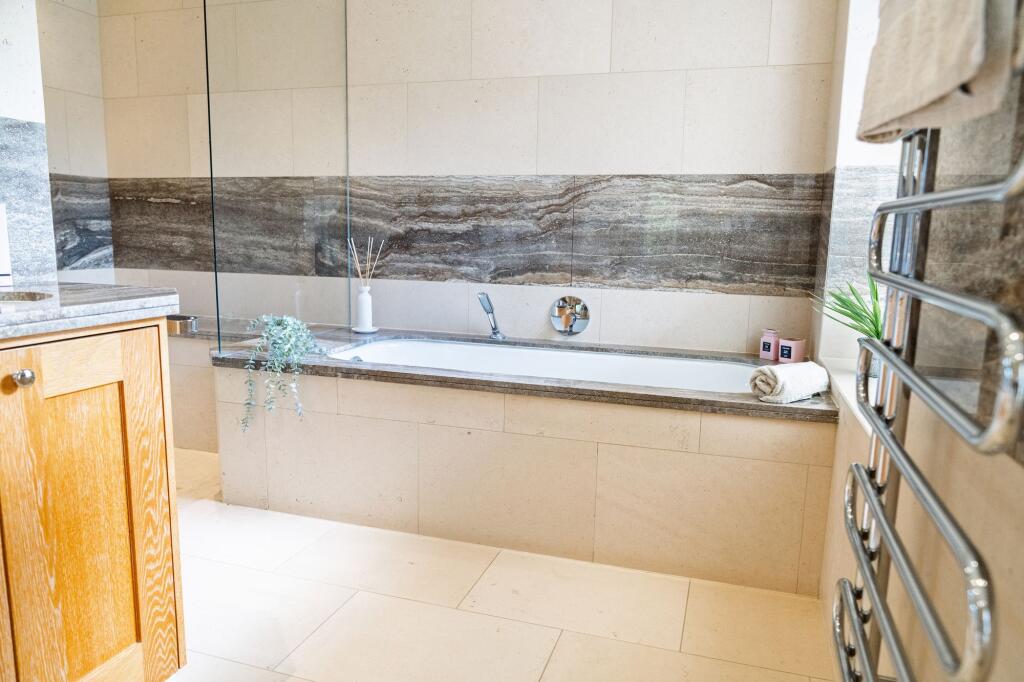 Master en suite with large bath tub and walk in rainfall shower