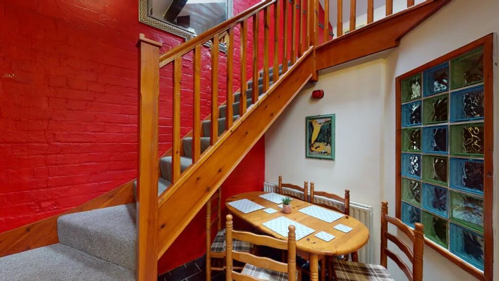 A charming staircase leading to an inviting upp...