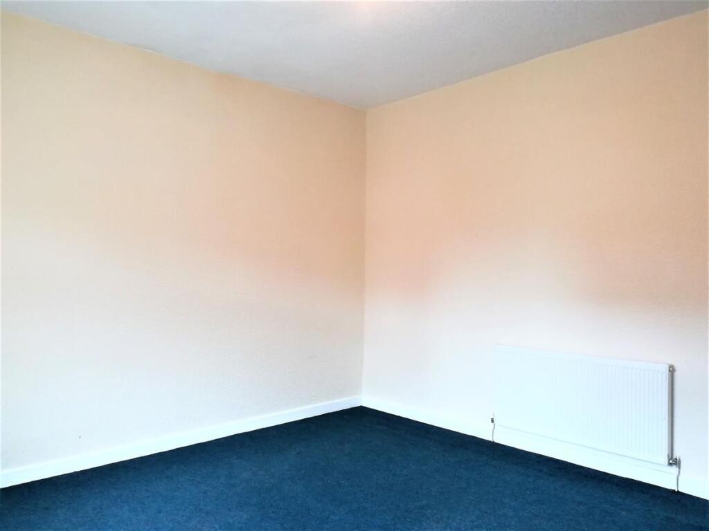 Bright, freshly painted bedroom with neutral wa...