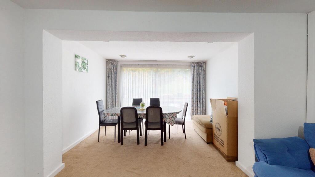 A well-lit, spacious living room featuring mode...