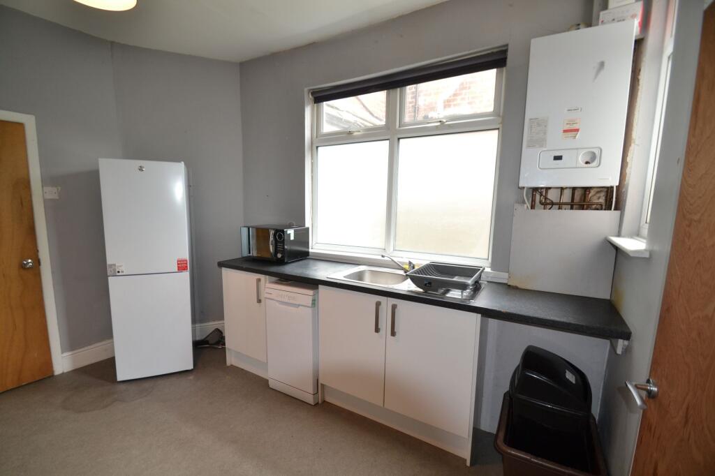 A simple and functional kitchen featuring a lar...